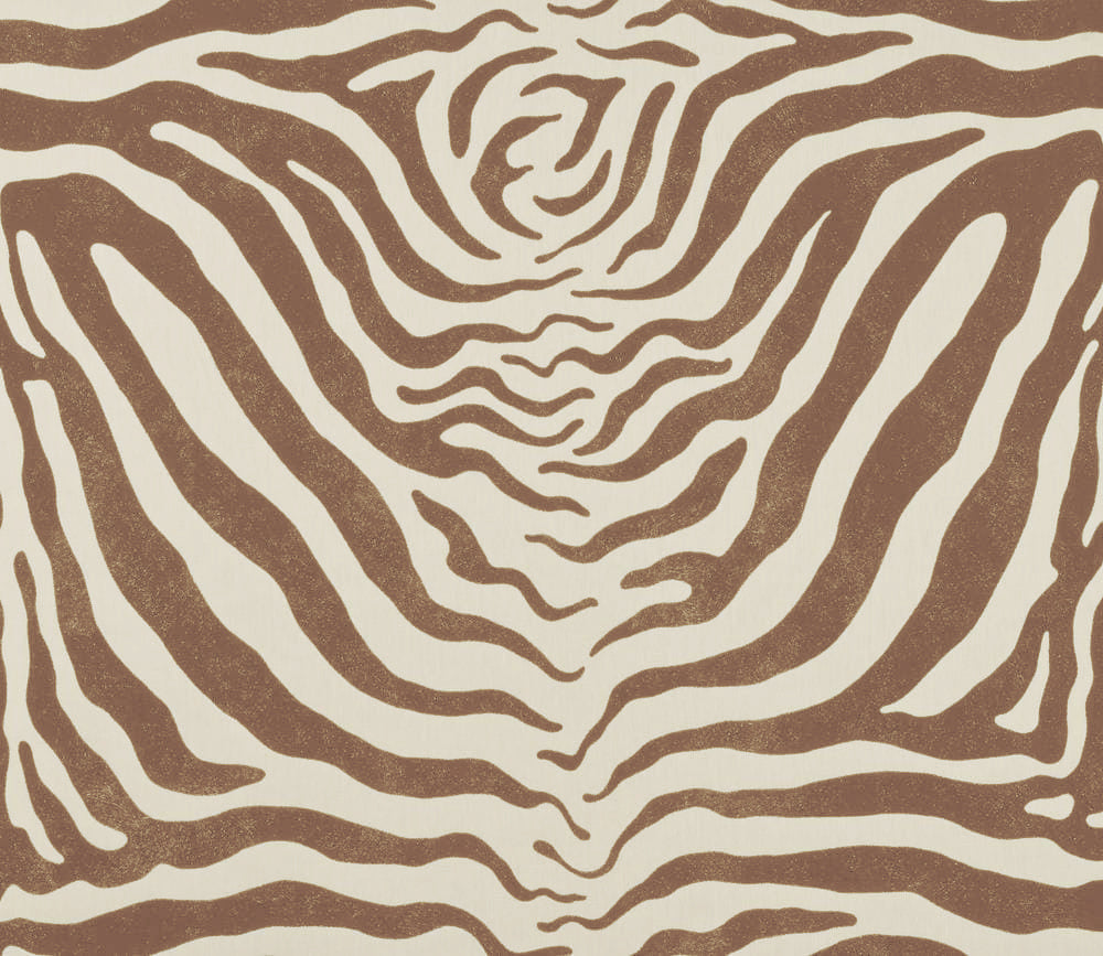 Detail of fabric in a zebra print in brown on a cream field.