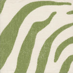 Detail of fabric in a zebra print in green on a cream field.