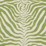 Detail of fabric in a zebra print in green on a cream field.