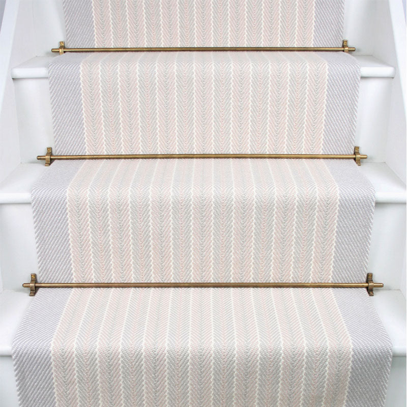 Striped herringbone flatweave runner in white and light grey on white staircase