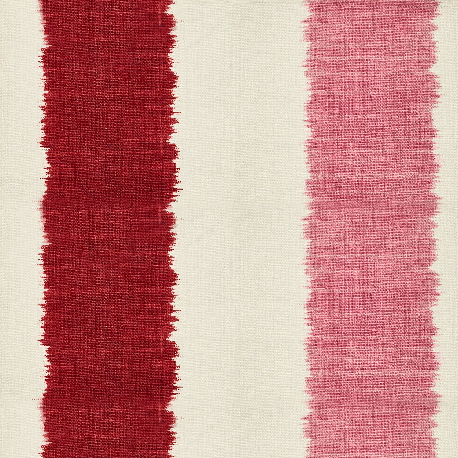 Detail of fabric in an ikat stripe print in shades of pink and red on a cream field.