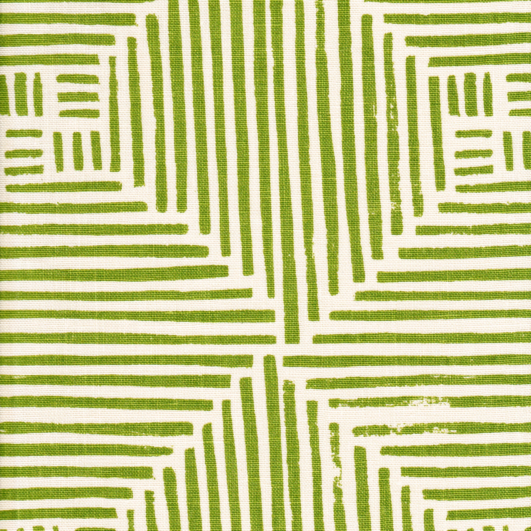 Detail of fabric in a dashed grid print in green on a cream field.