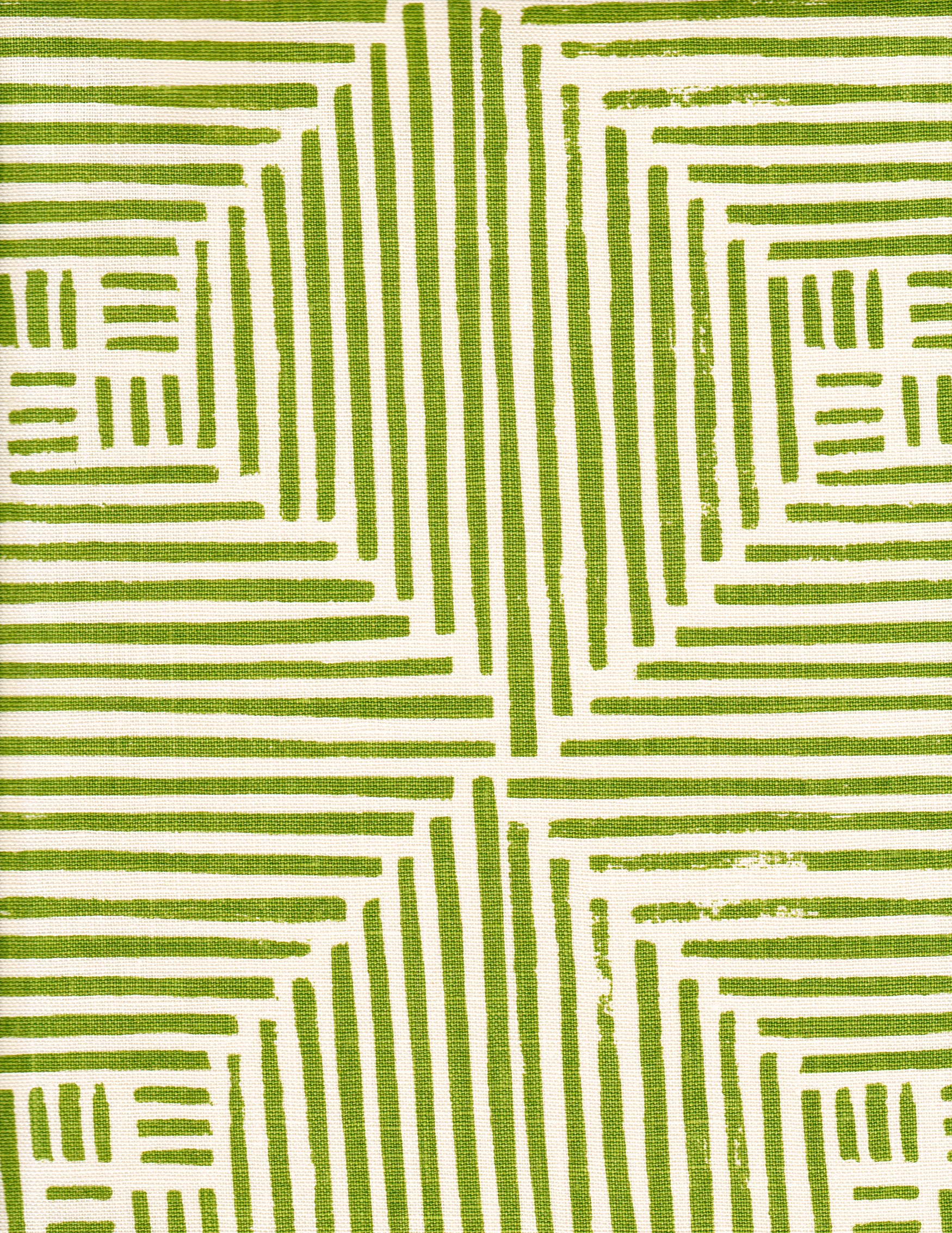 Detail of fabric in a dashed grid print in green on a cream field.