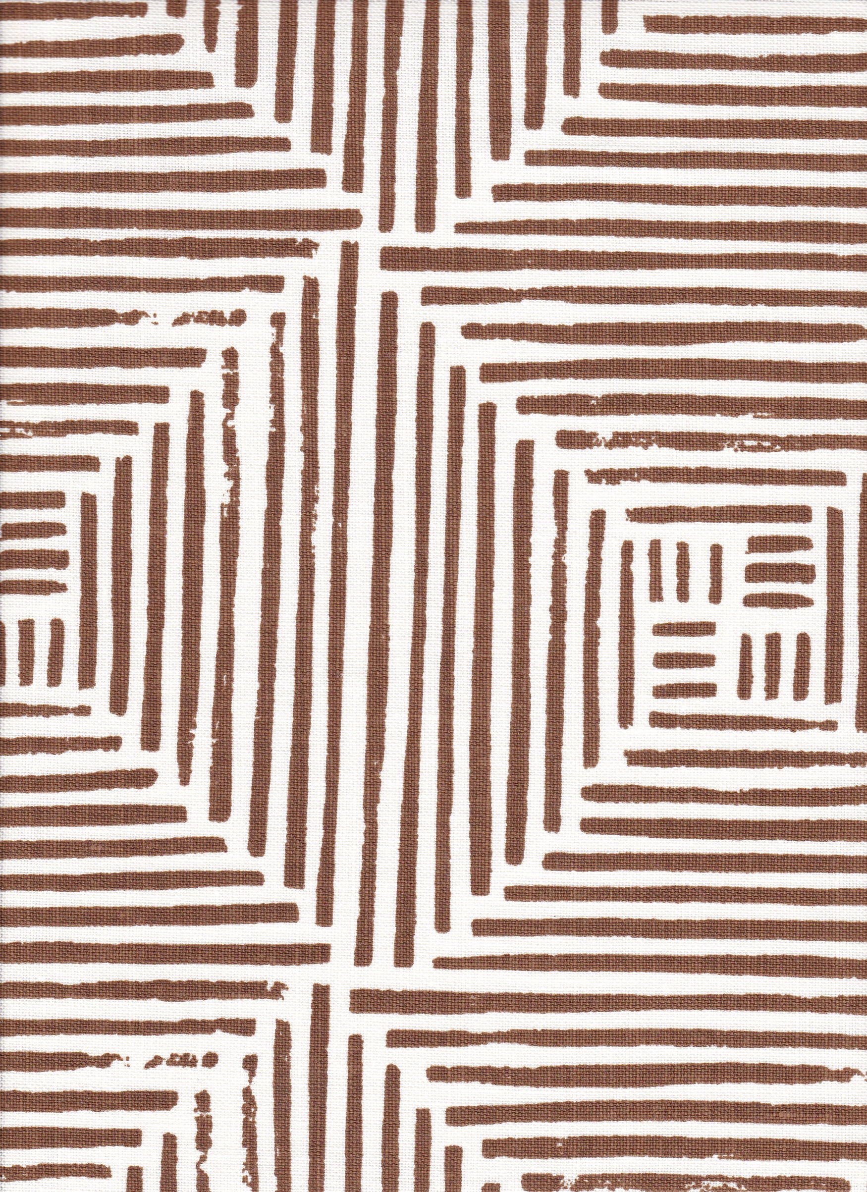 Detail of fabric in a dashed grid print in brown on a white field.