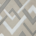 Detail of wallpaper in an interlocking zig zag print in shades of white, gray and tan.