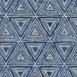 Detail of fabric in a triangular grid print in shades of blue and navy.