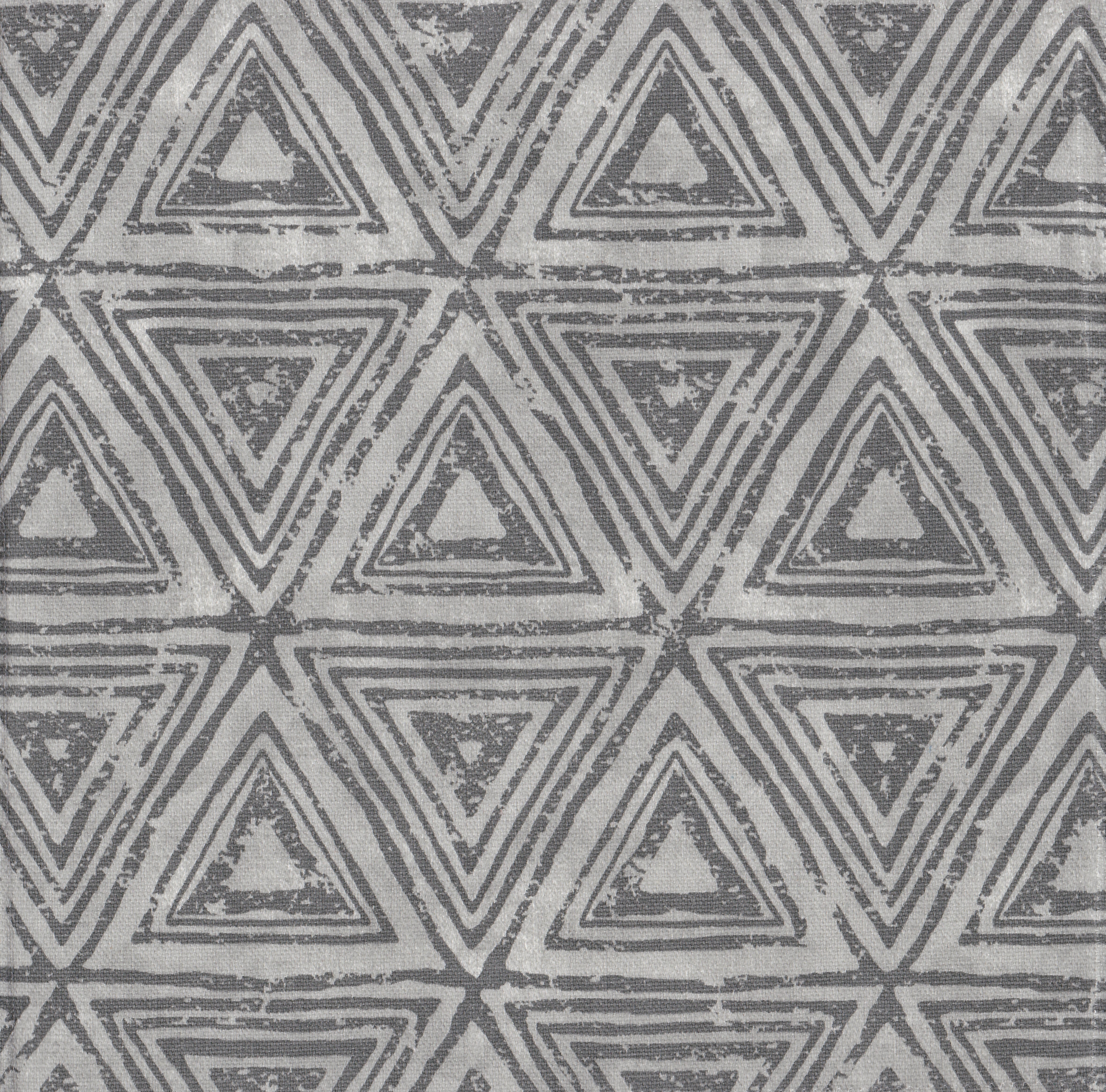 Detail of fabric in a triangular grid print in shades of gray.