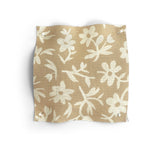 Fabric swatch with beige and white floral pattern on a white background