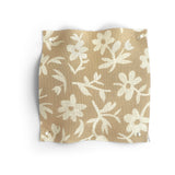 Fabric swatch with beige and white floral pattern on a white background