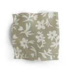 Fabric swatch with  of small white flowers on taupe on a white background