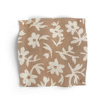 Fabric swatch with small white flowers on a terracotta background