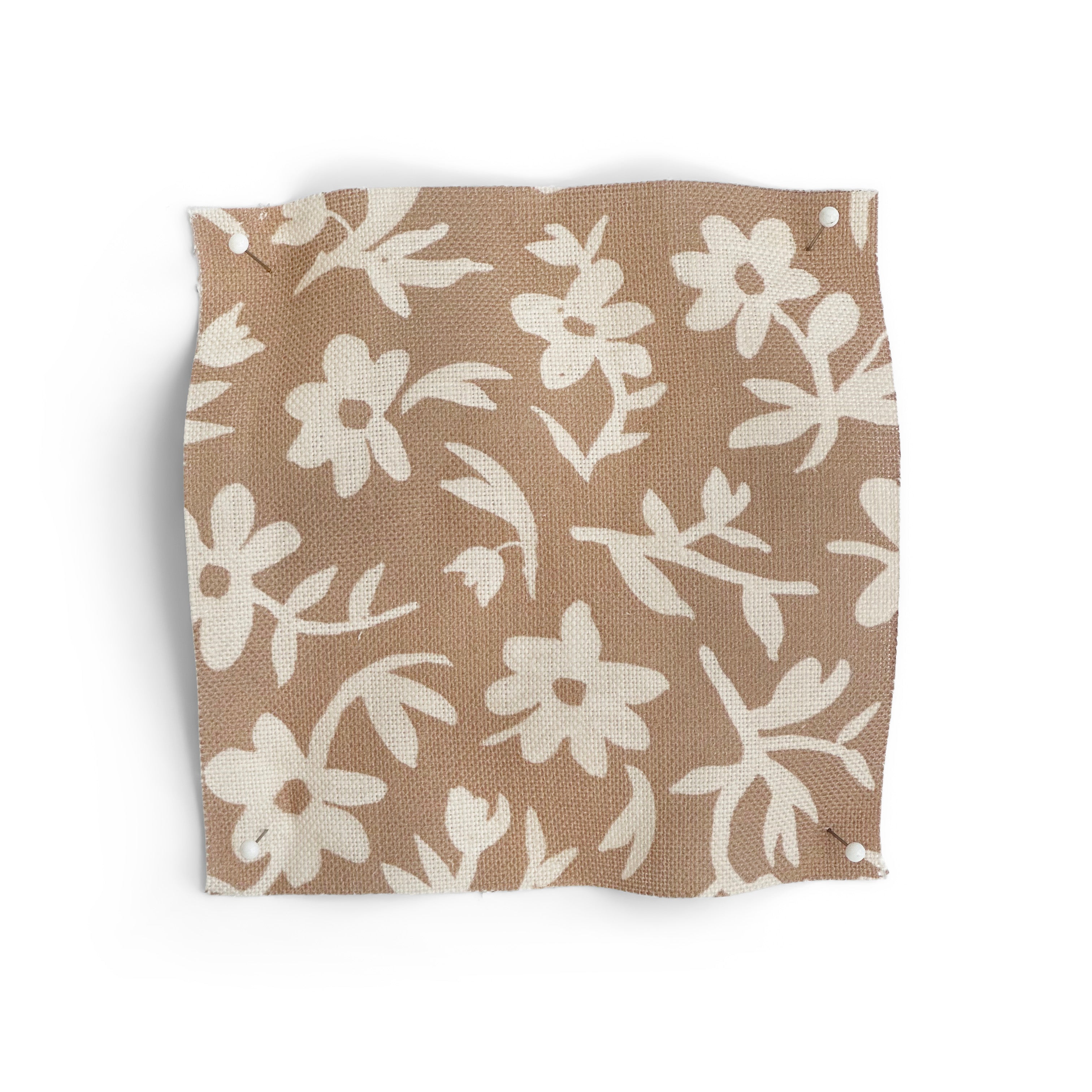 Fabric swatch with small white flowers on a terracotta background