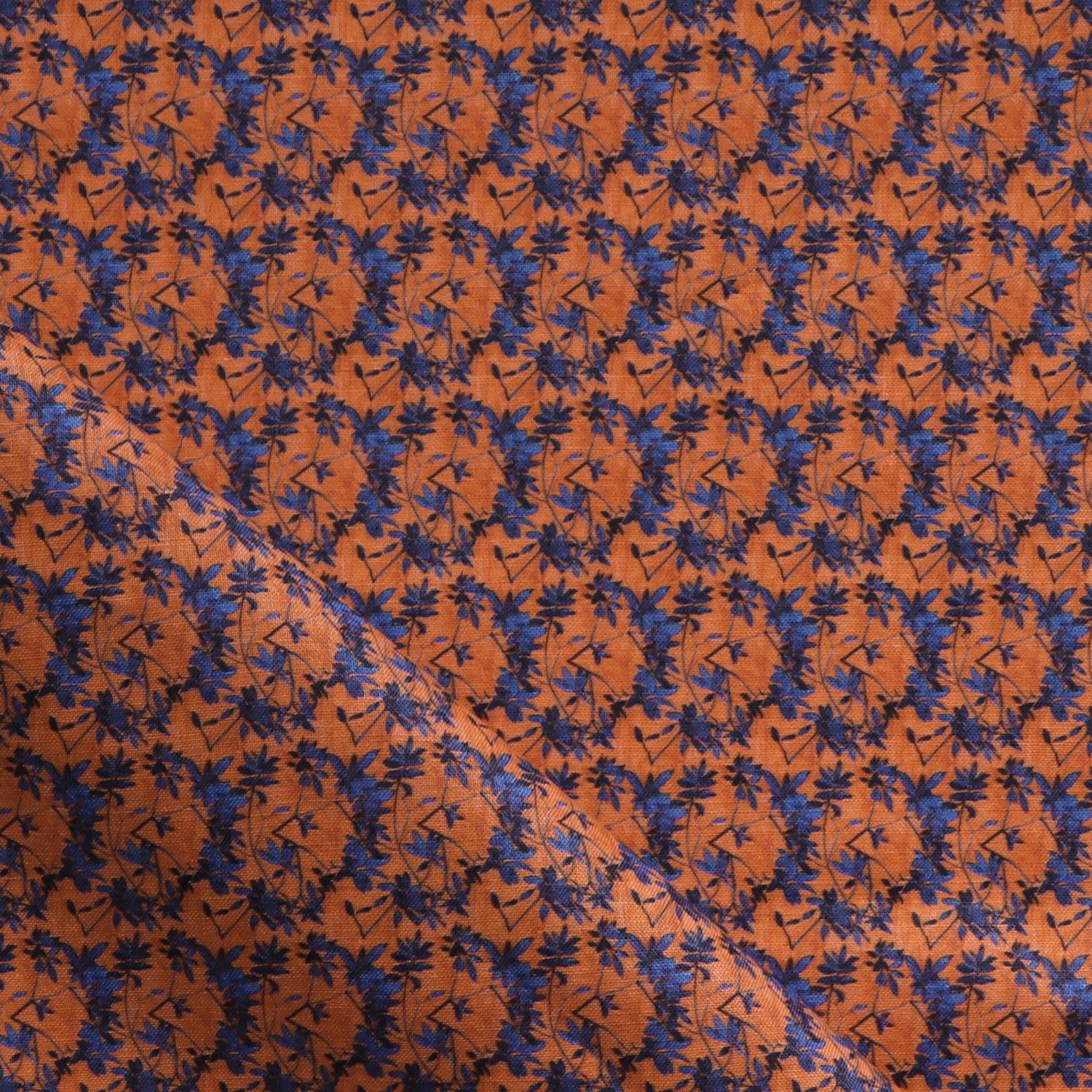 Fabric with small scale watercolor floral in blue and orange.