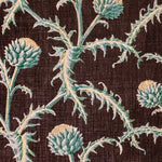 Detail of fabric in a repeating artichoke print in shades of turquoise and gold on a brown field.