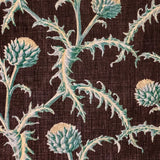 Detail of fabric in a repeating artichoke print in shades of turquoise and gold on a brown field.