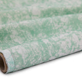 Partially unrolled fabric in an organic crumpled texture in light green on a cream field.