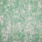 Detail of velvet fabric in an organic crumpled texture in light green on a cream field.
