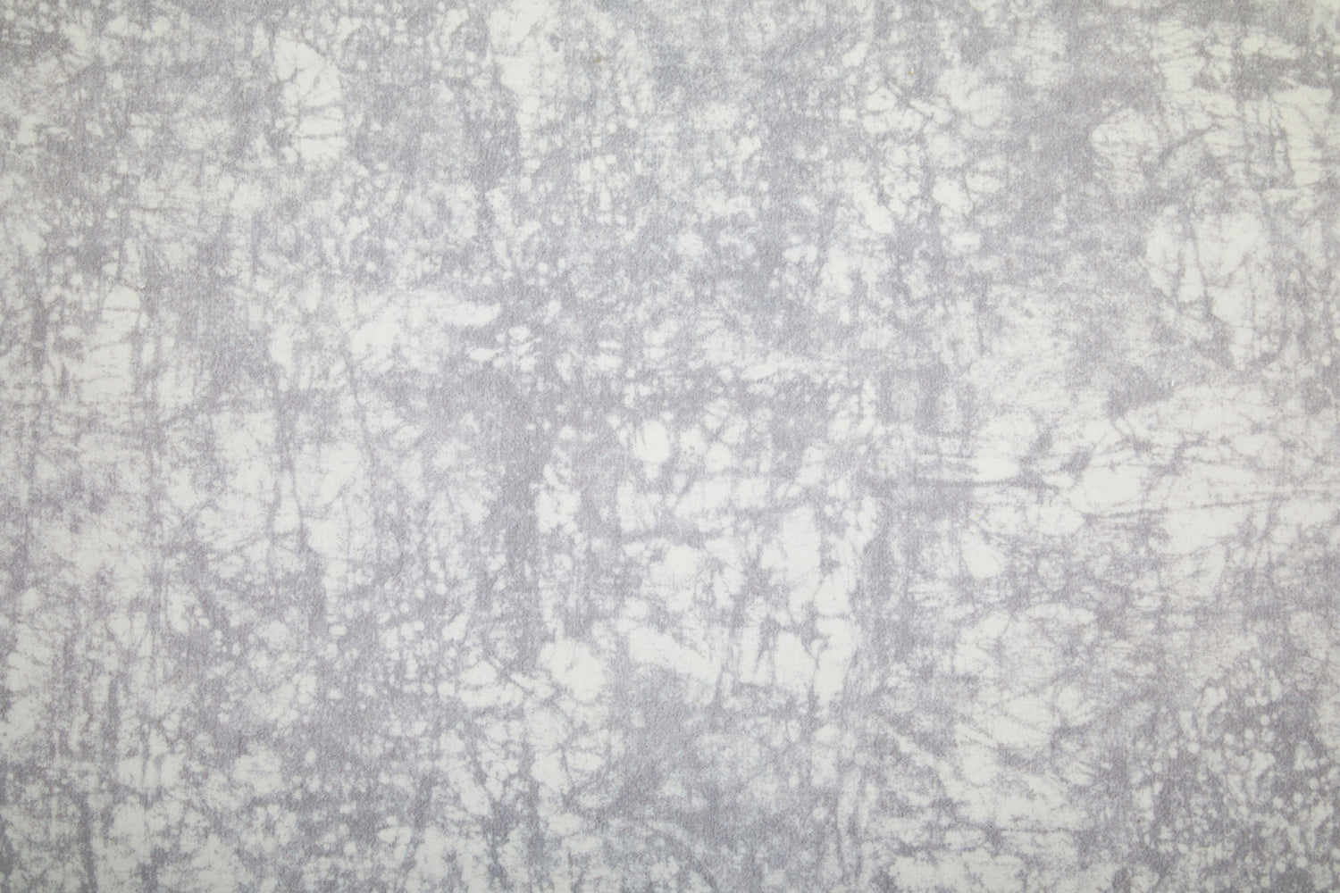 Detail of velvet fabric in an organic crumpled texture in light gray on a cream field.