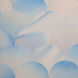 Detail of wallpaper in a repeating scalloped print in shades of blue and tan.