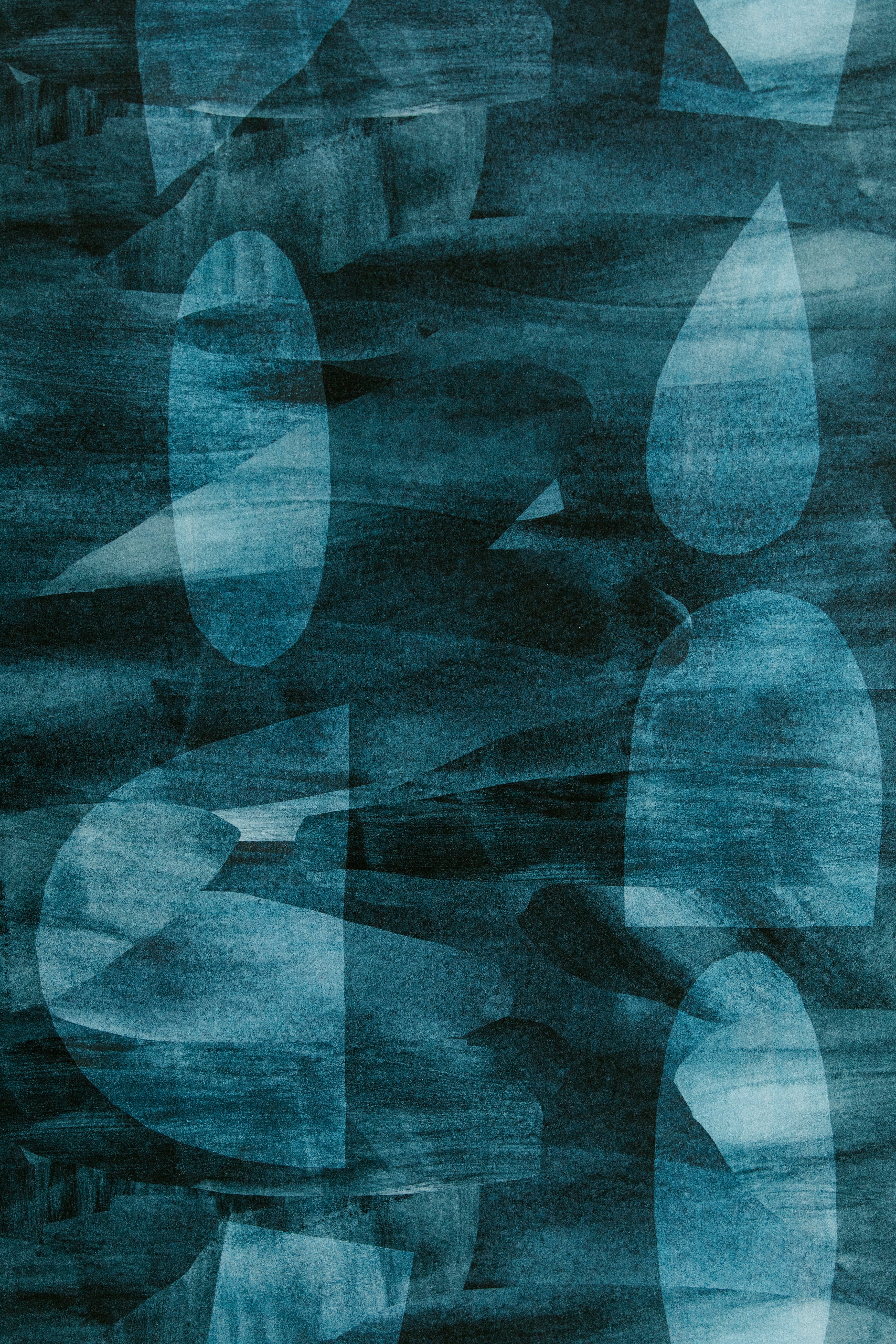 Detail of wallpaper in an abstract curvolinear pattern in shades of turquoise, navy and black.