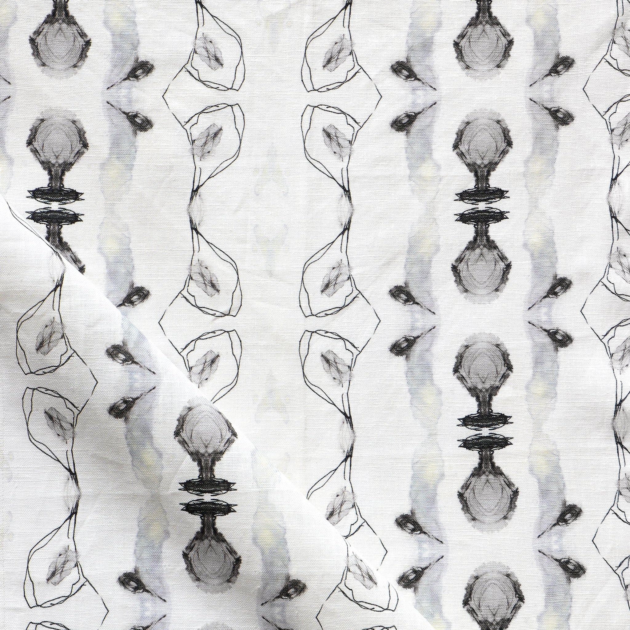 Detail of draped fabric yardage in an abstract ikat stripe print in shades of gray and black on a white field.