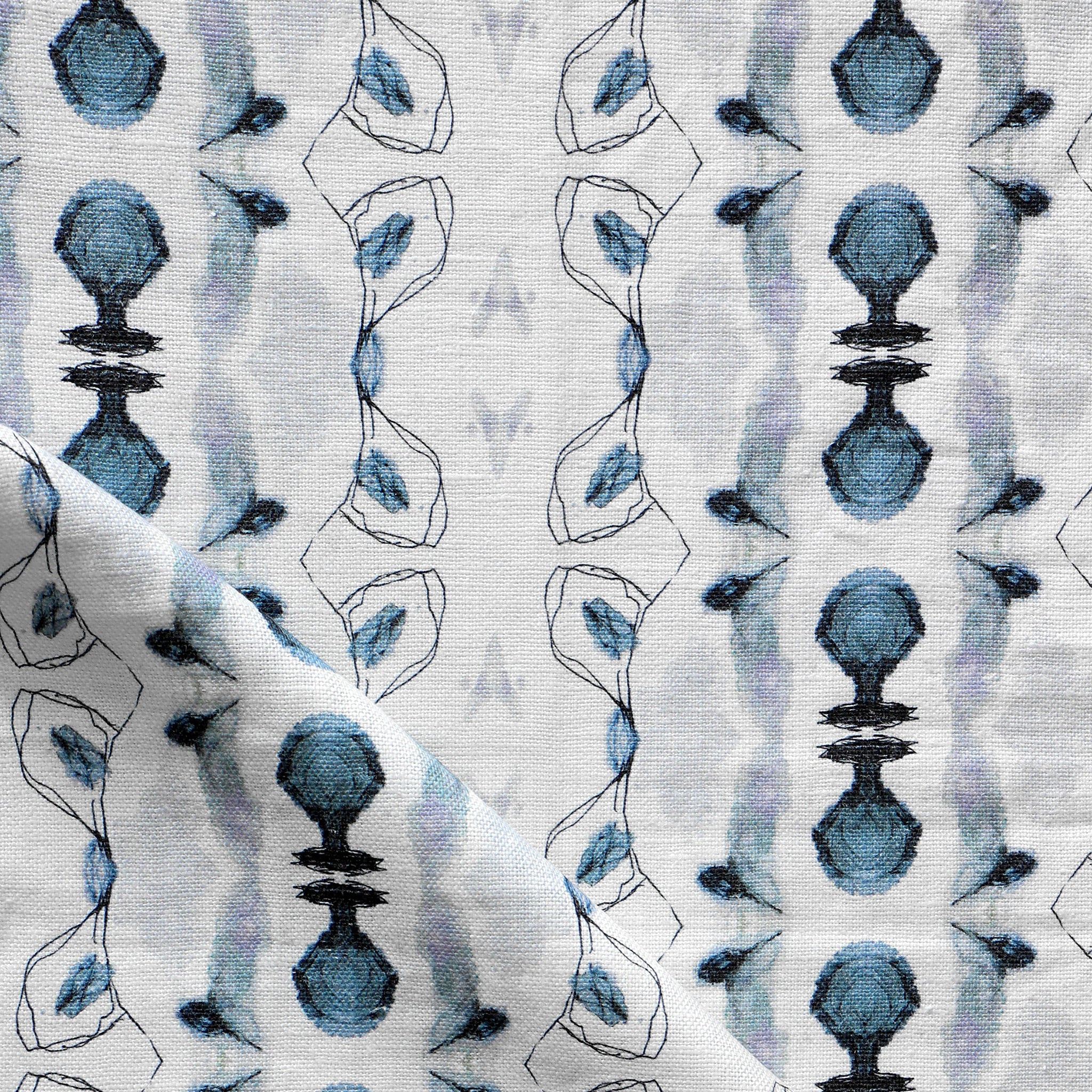 Detail of draped fabric yardage in an abstract ikat stripe print in shades of blue and black on a white field.