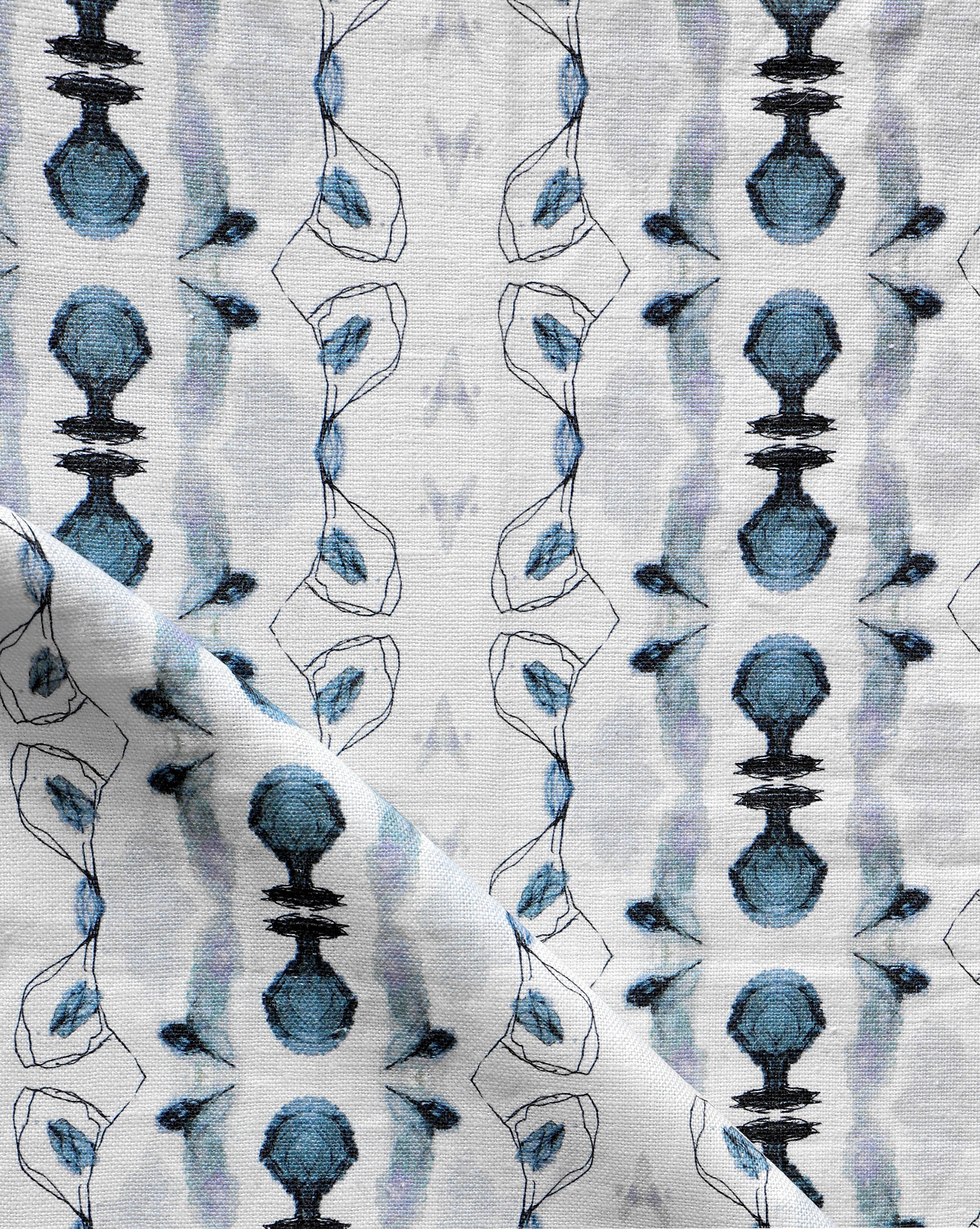 Detail of draped fabric yardage in an abstract ikat stripe print in shades of blue and black on a white field.