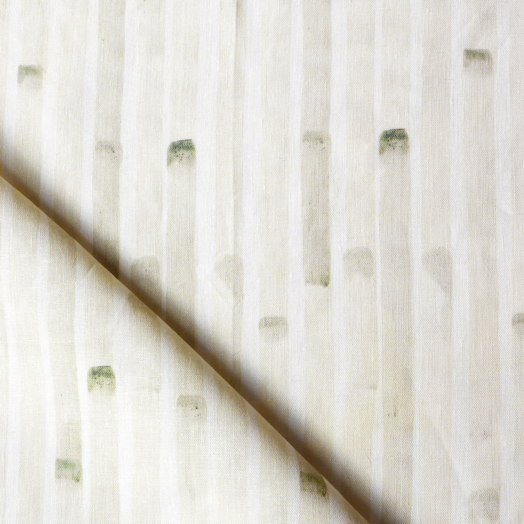 Detail of draped fabric in a painterly stripe print in tan on a white field.