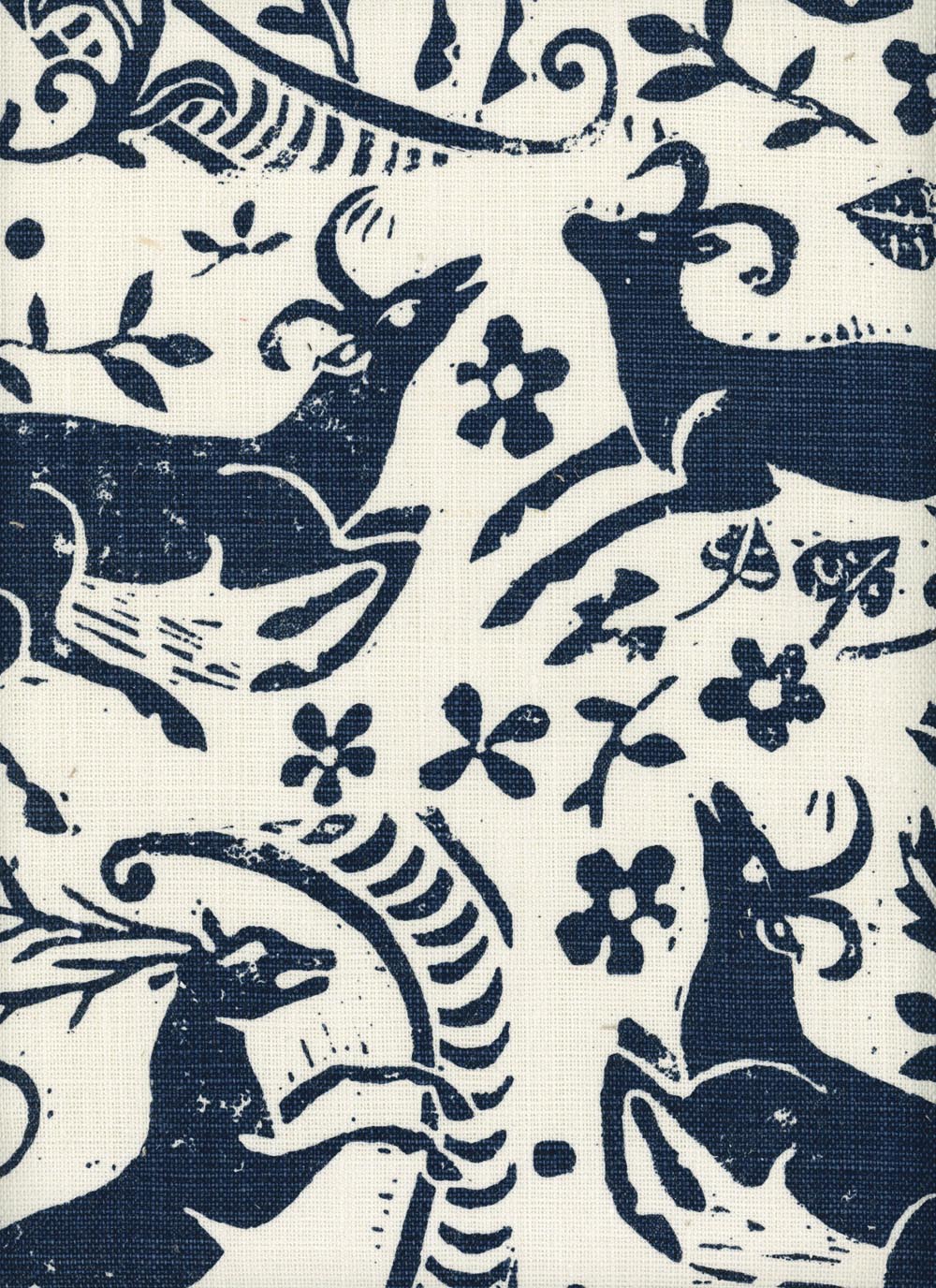 Close-up of fabric in a deer, leaf and flower print in navy on a white field.