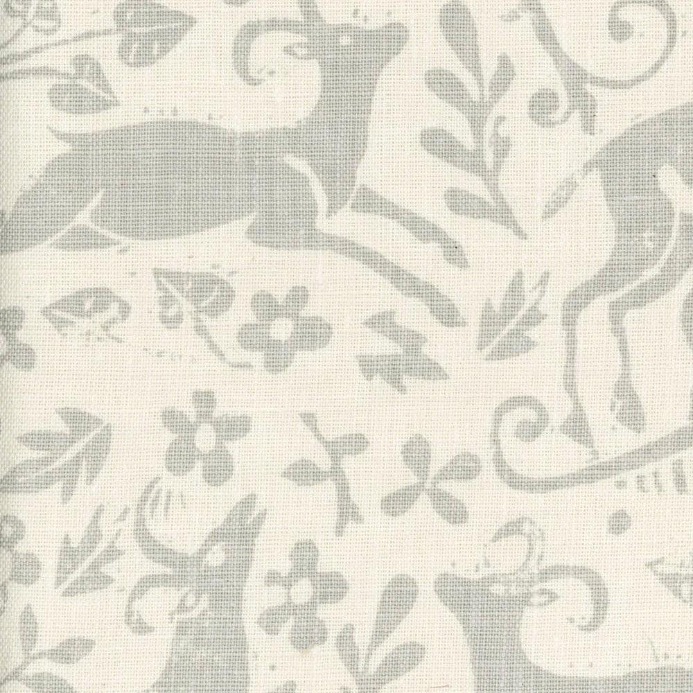 Close-up of fabric in a deer, leaf and flower print in light gray on a cream field.