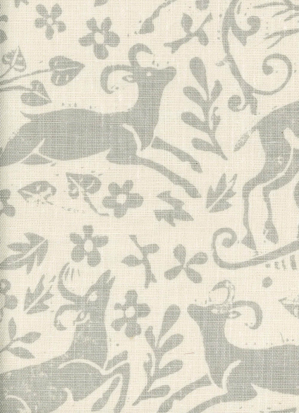 Close-up of fabric in a deer, leaf and flower print in light gray on a cream field.