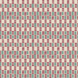 Detail of fabric in a geometric check print in shades of red, cream and turquoise.