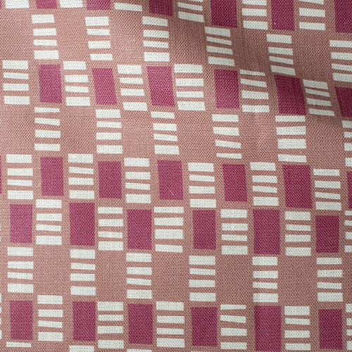 Draped fabric in a geometric check print in shades of red, cream and tan.