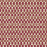 Detail of fabric in a geometric check print in shades of red, cream and tan.