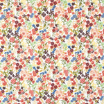 Detail of fabric in a dense small-scale floral print in shades of coral, red, green and blue on a white field.