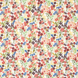 Detail of fabric in a dense small-scale floral print in shades of coral, red, green and blue on a white field.