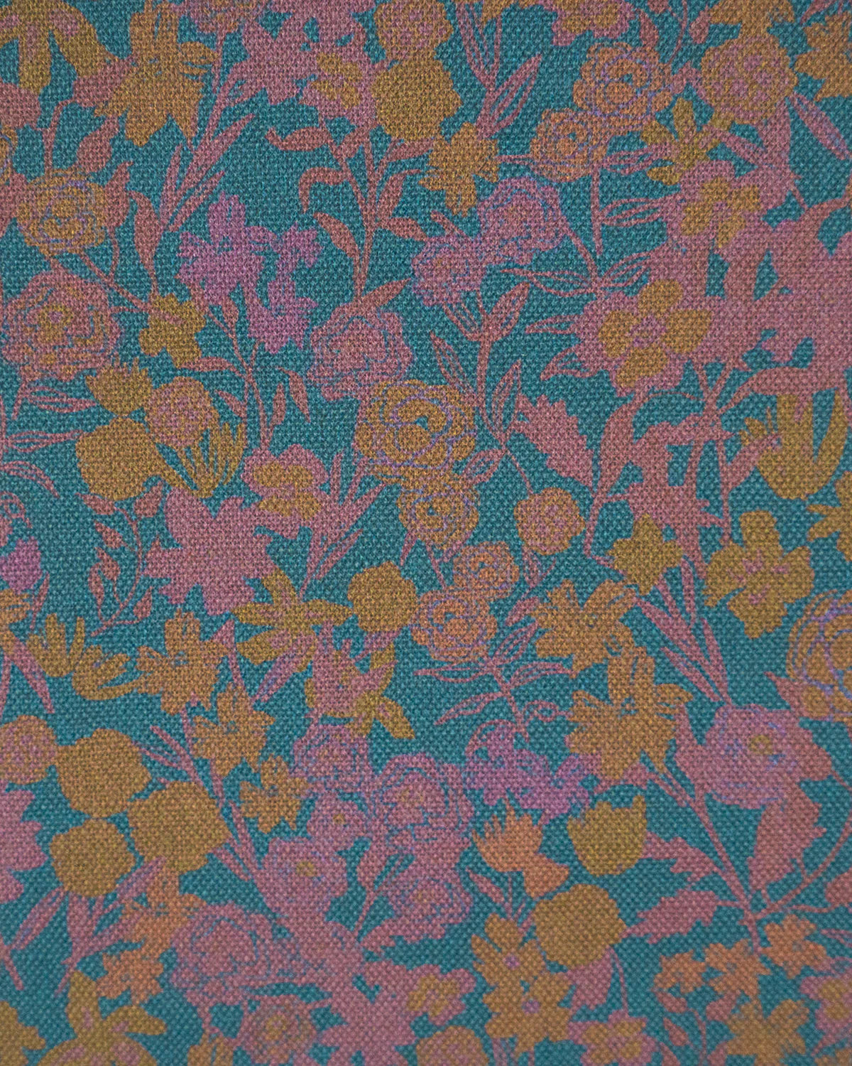 Detail of fabric in a dense small-scale floral print in shades of purple and gold on a navy field.