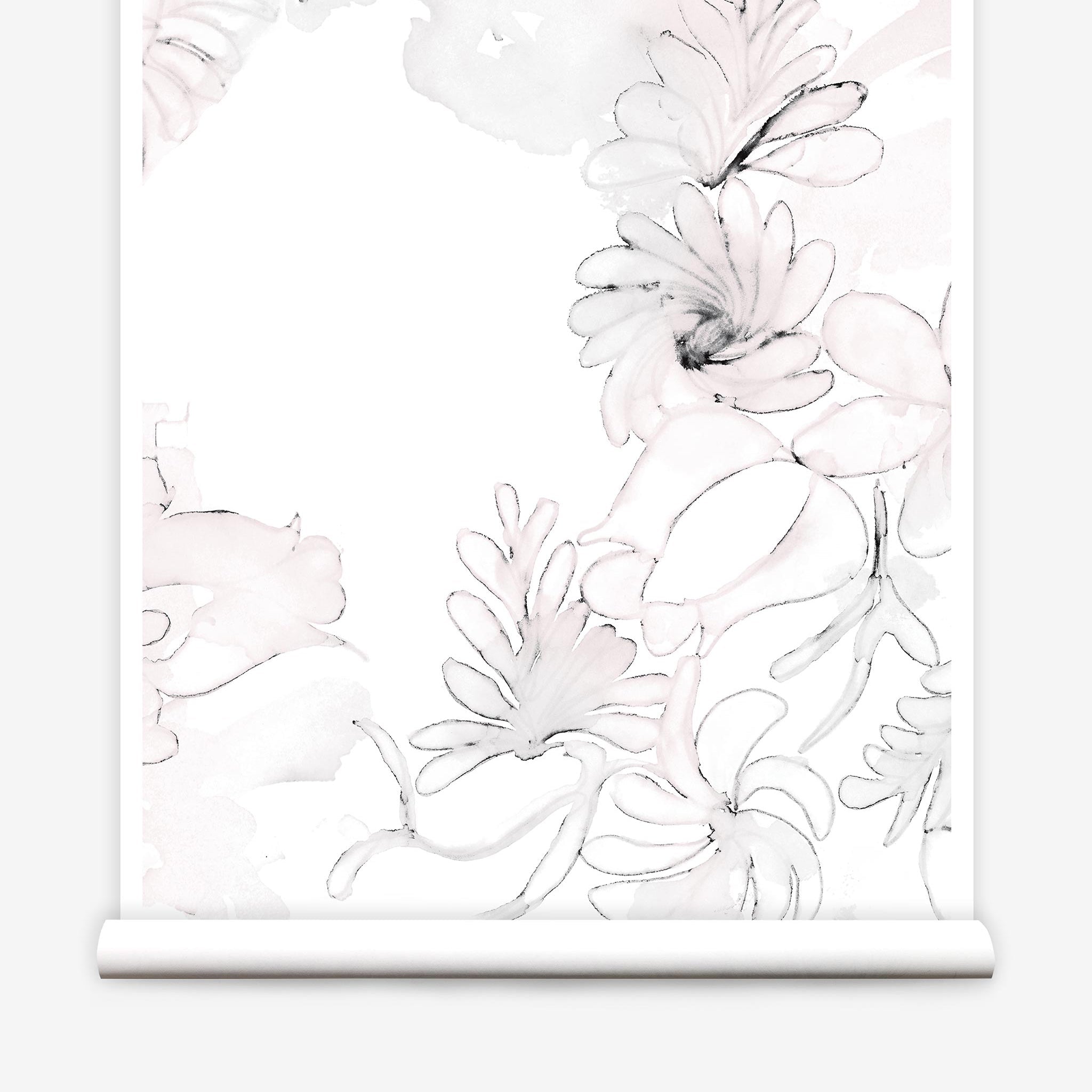 Partially unrolled wallpaper yardage in a painterly floral print in shades of pink and charcoal on a white field.