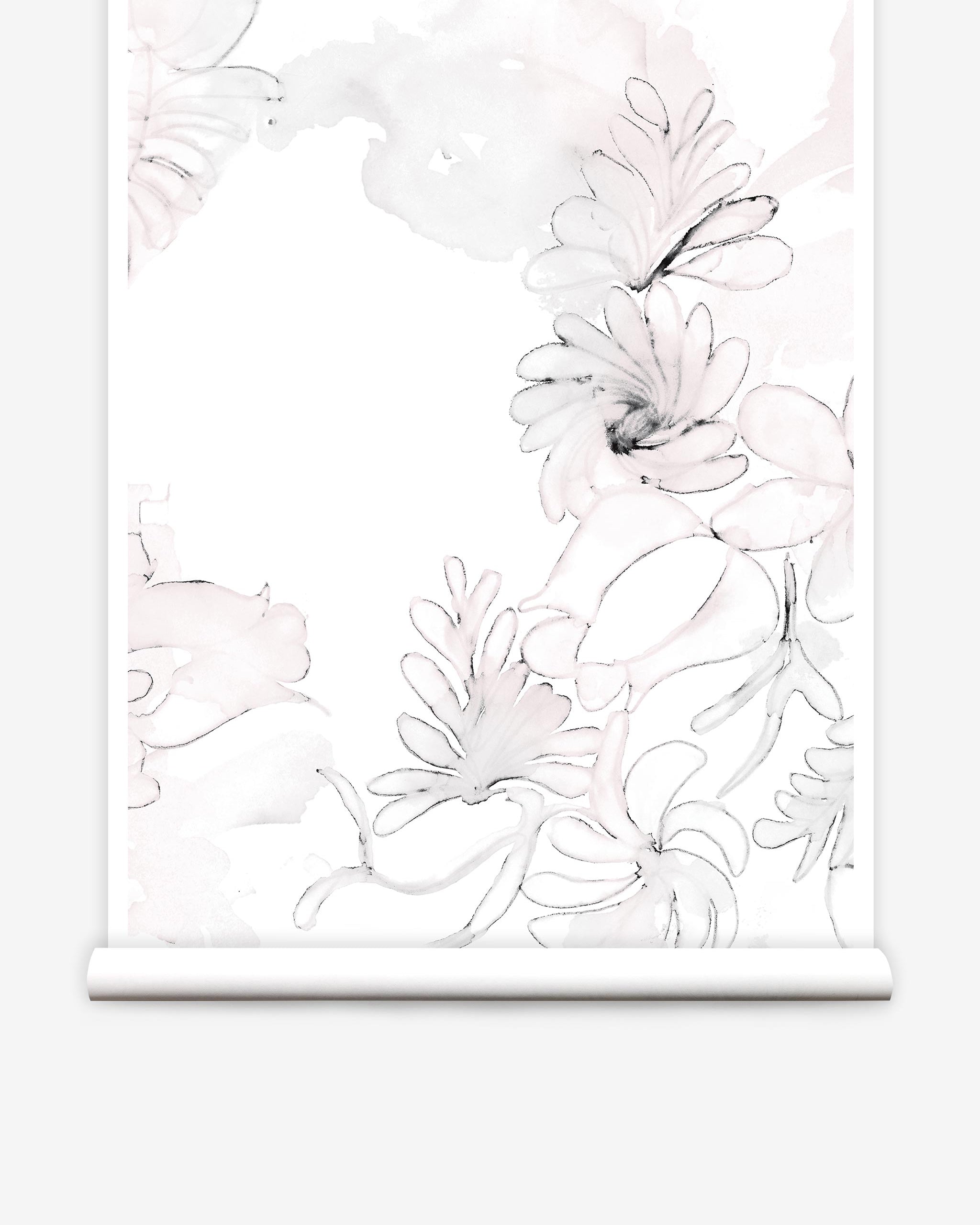 Partially unrolled wallpaper yardage in a painterly floral print in shades of pink and charcoal on a white field.