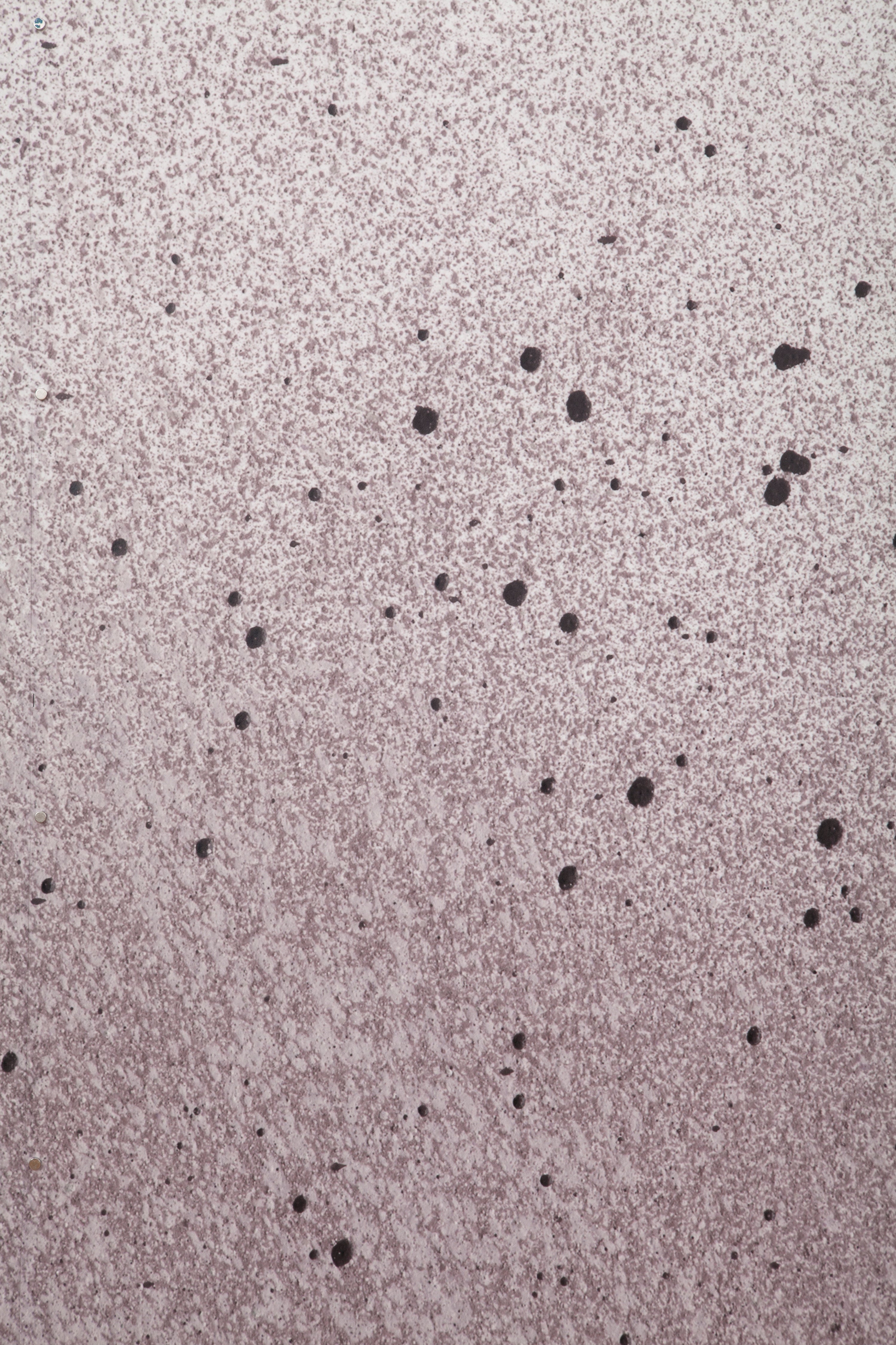 Close up of paint splatters in purple, gray and white.