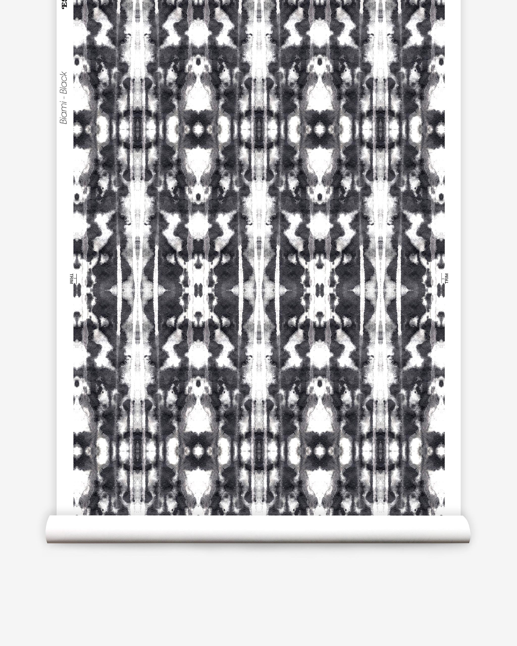 Partially unrolled wallpaper yardage in a painterly ikat print in black on a white field.