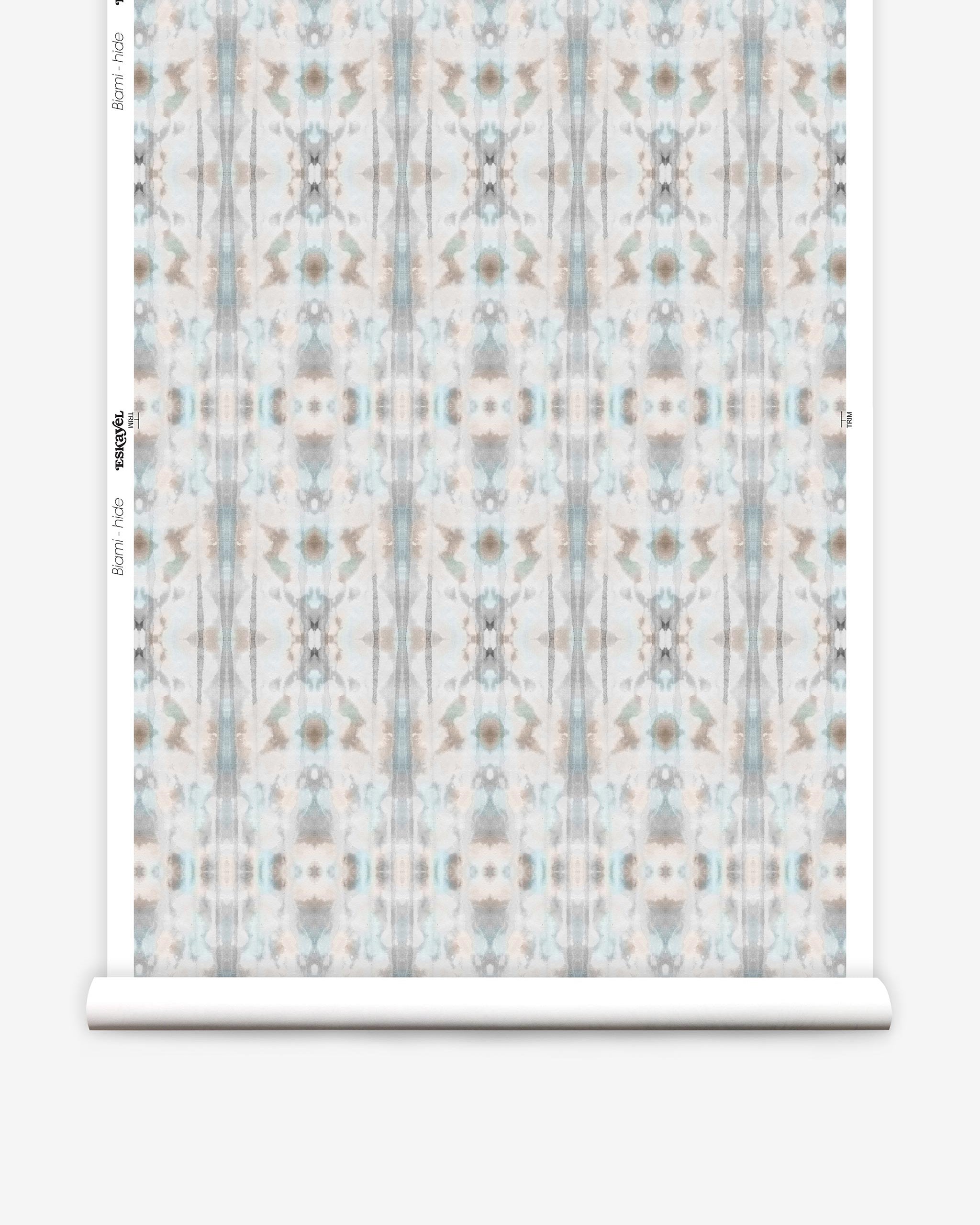 Partially unrolled wallpaper yardage in a painterly ikat print in turquoise, gray and tan.