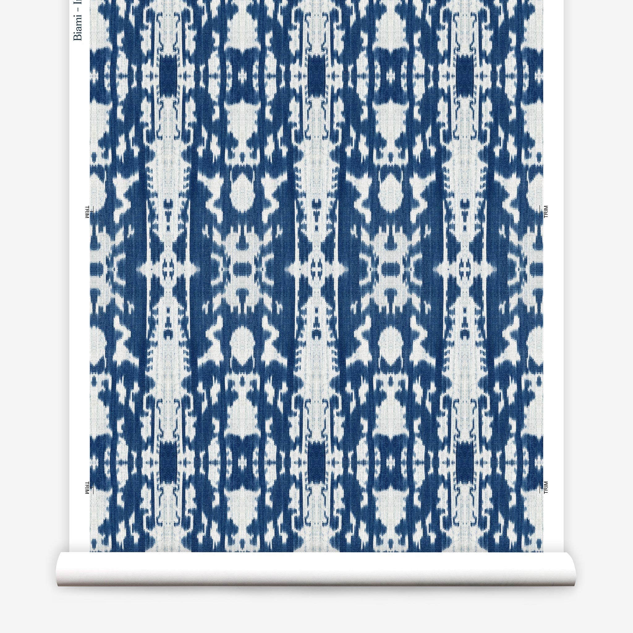 Partially unrolled wallpaper yardage in a painterly ikat print in blue and white.