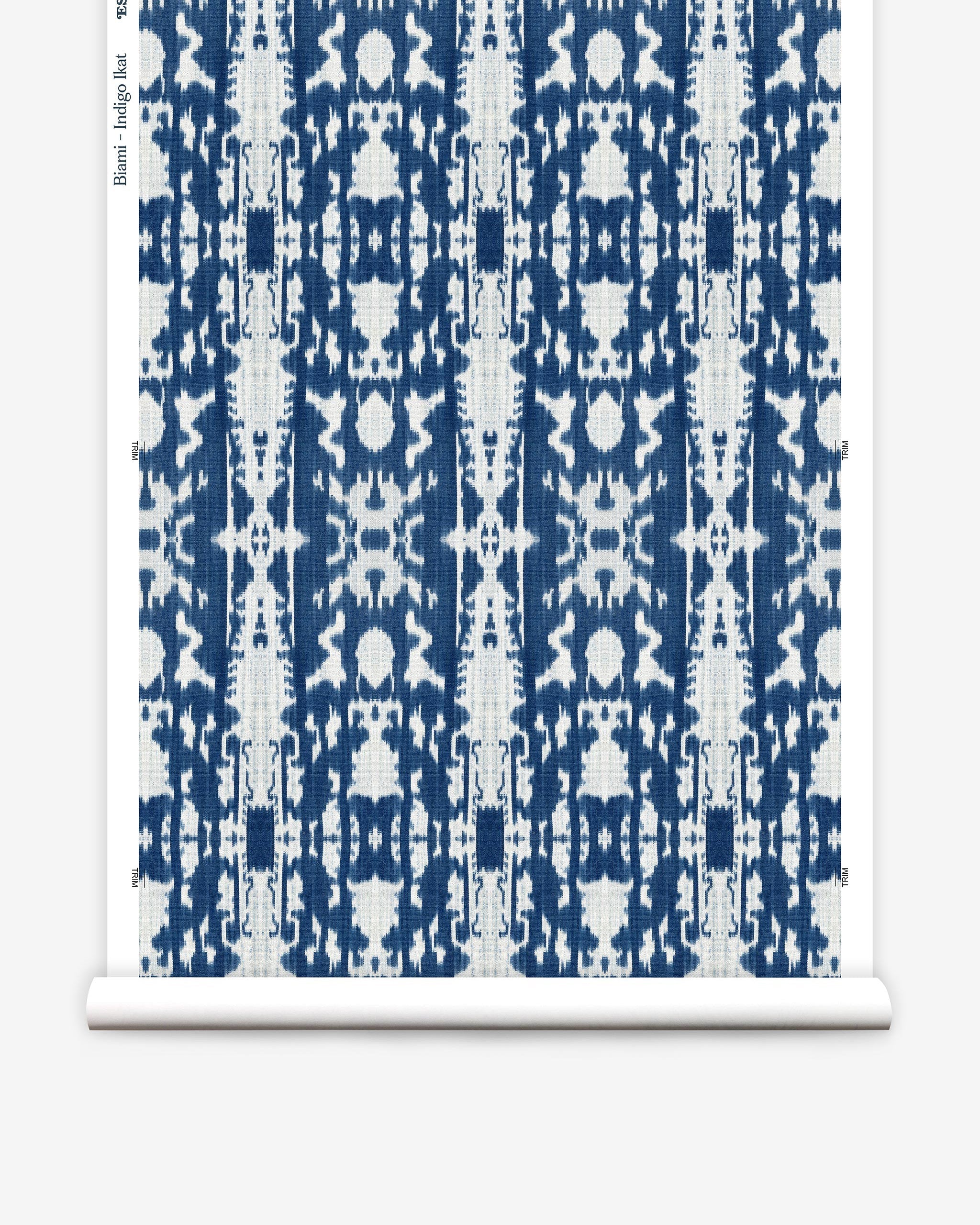 Partially unrolled wallpaper yardage in a painterly ikat print in blue and white.