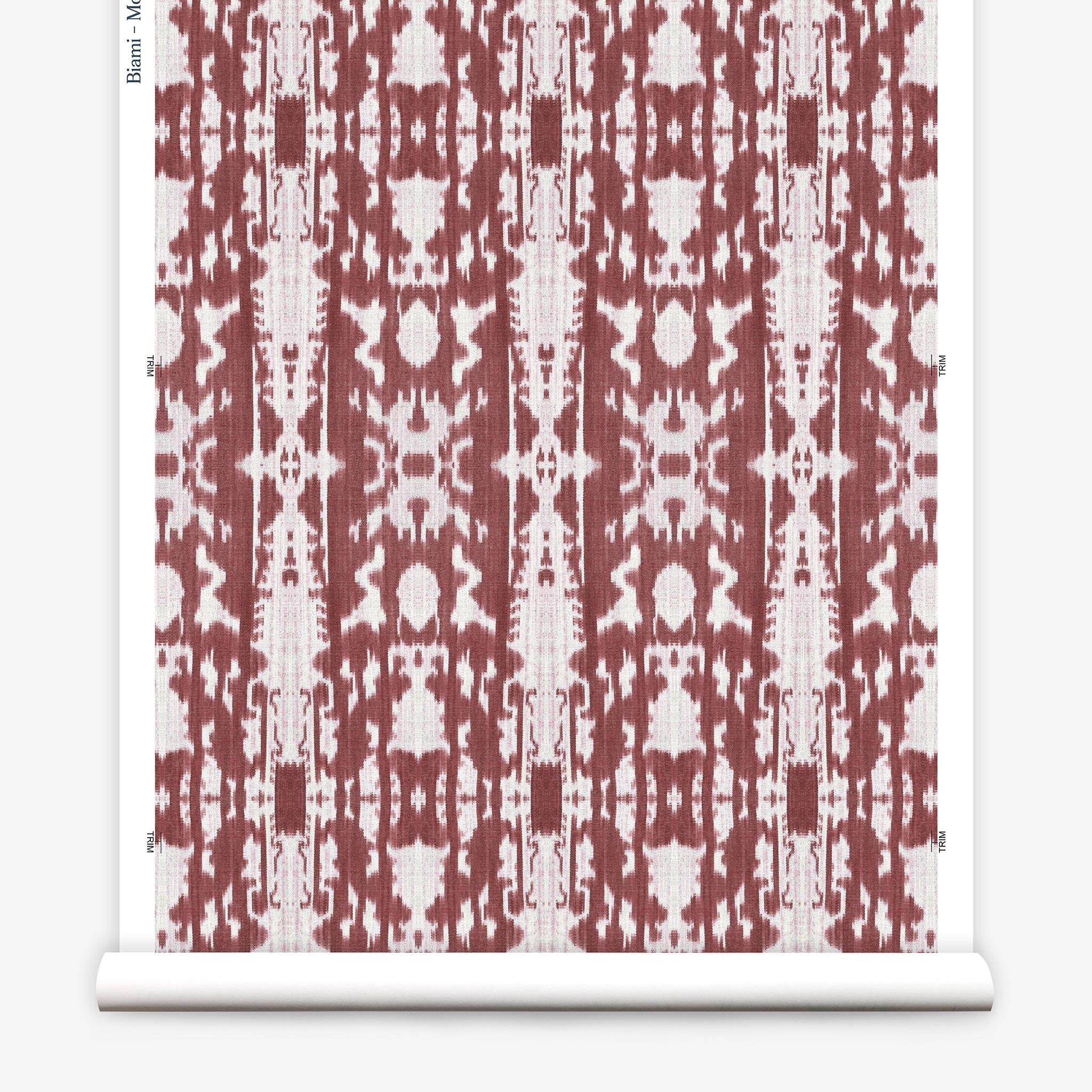 Partially unrolled wallpaper yardage in a painterly ikat print in rust and white.