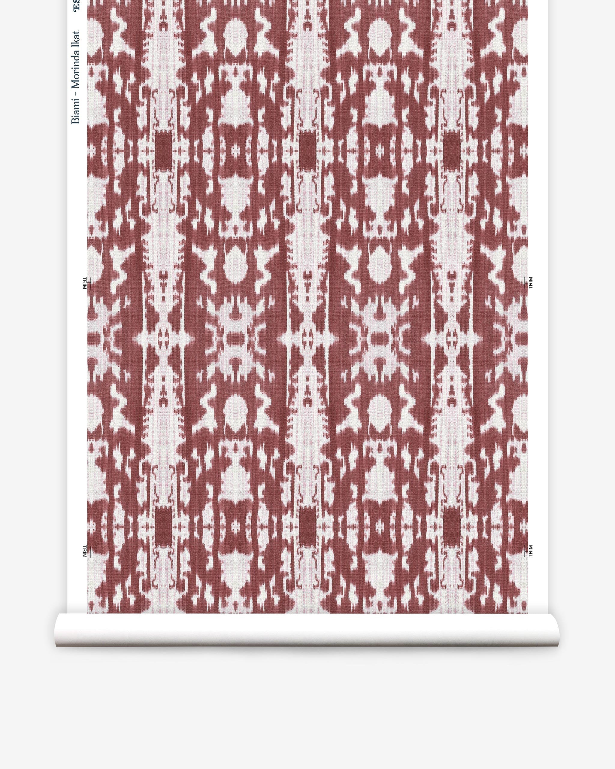 Partially unrolled wallpaper yardage in a painterly ikat print in rust and white.