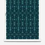 Partially unrolled wallpaper yardage in a painterly ikat print in turquoise and navy.