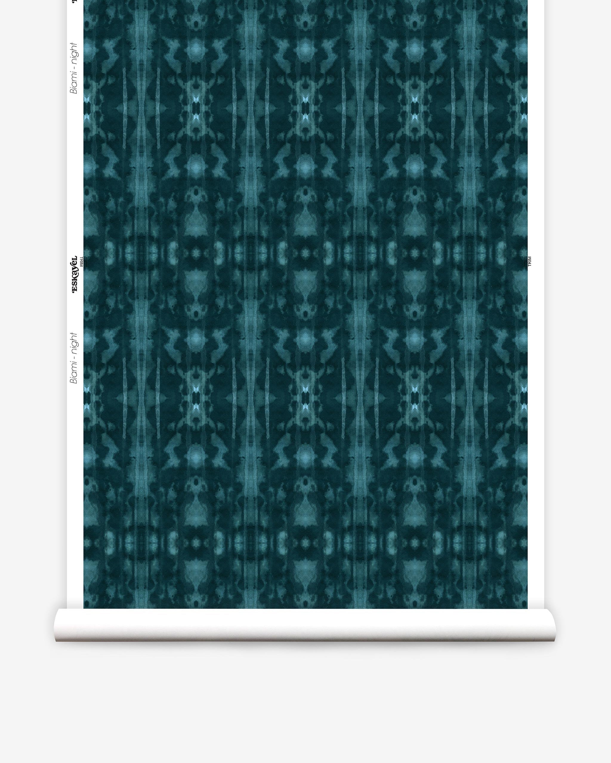 Partially unrolled wallpaper yardage in a painterly ikat print in turquoise and navy.