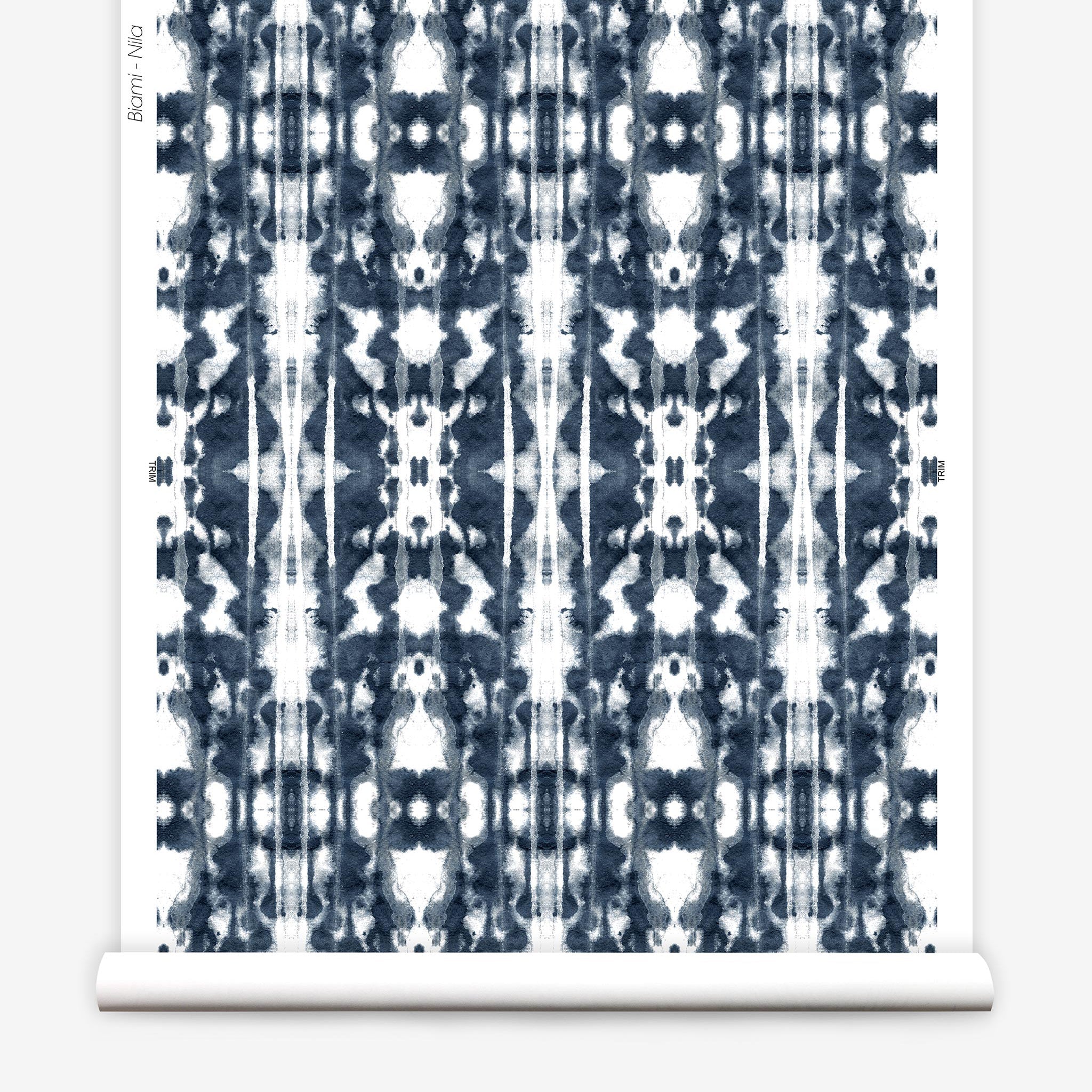 Partially unrolled wallpaper yardage in a painterly ikat print in navy and white.