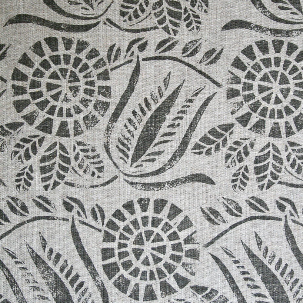 Close-up of fabric in a dense floral print in gray on a white field.